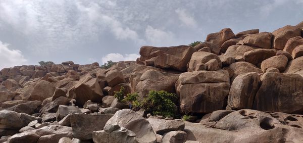 Low angle view of rocks against sky