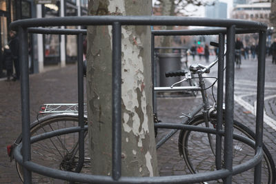 Bicycle parked by railing in city