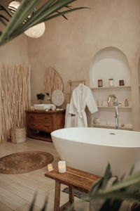 Luxury interior of big bathroom at modern african style with oval bathtub in natural lighting