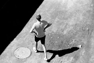 High angle view of woman standing by wall