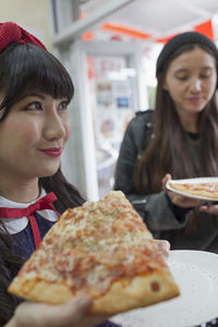 Portrait of a smiling young woman in restaurant