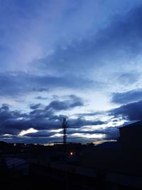 Low angle view of silhouette buildings against sky at dusk