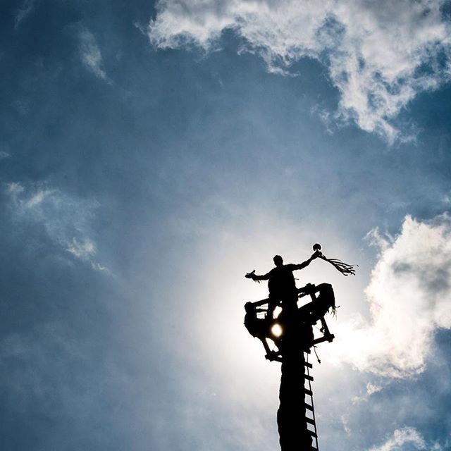 low angle view, sky, silhouette, cloud - sky, transportation, sculpture, statue, mode of transport, human representation, cloudy, cloud, art and craft, airplane, men, art, air vehicle, outdoors, creativity, animal representation