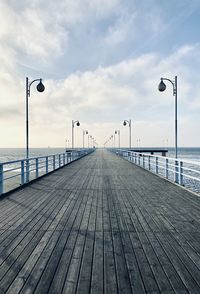 Pier over sea against sky