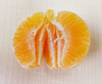 Close-up of orange fruit against white background