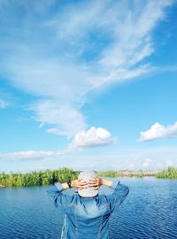 Portrait of man in lake against blue sky