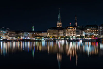 Reflection of illuminated buildings in city at night