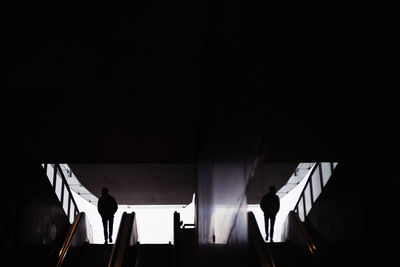 Silhouette of person on escalator