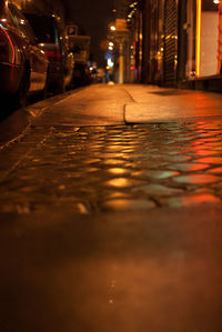 Surface level of car on illuminated street at night