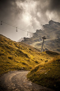 Low angle view of ski lift over mountains against sky