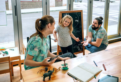 Portrait of smiling friends sitting at home