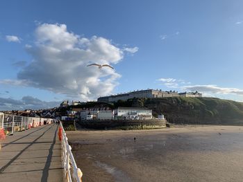 Road by sea against sky in city