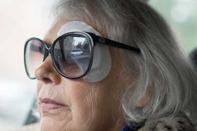 Close-up of woman with bandage on eye