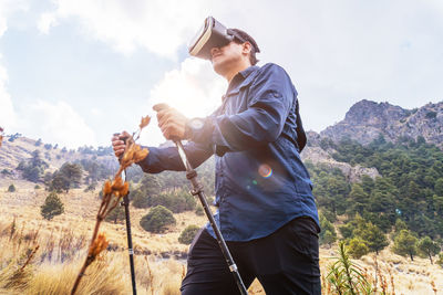 Man wearing virtual reality headset in field