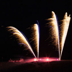 Low angle view of firework display at night