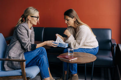 Millennial european woman in depression at the reception of a psychologist