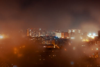 High angle view of illuminated buildings in city at night