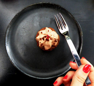 Close-up of cropped woman having dessert at home