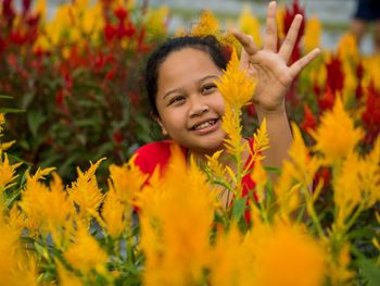 Portrait of smiling girl with yellow flowers