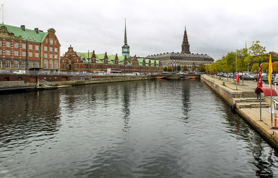 View of boats in river with buildings in background