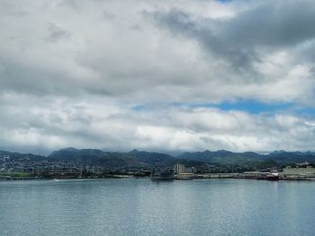 Scenic view of sea by city against sky