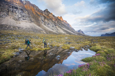 Reflection of backpackers exploring akshayak pass