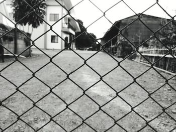 Close-up of chainlink fence against sky