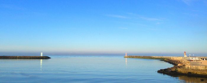 Scenic view of sea against clear blue sky