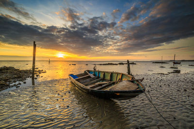 Fishing boat on sea during sunset