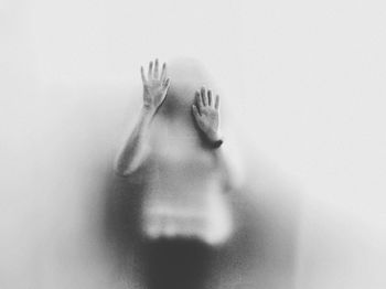 Woman seen through condensed glass window