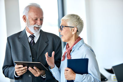 Businesswoman discussing with colleague in office