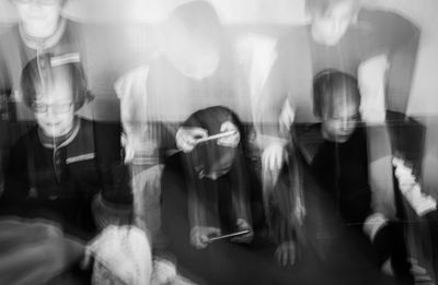 Digital composite image of people sitting in restaurant