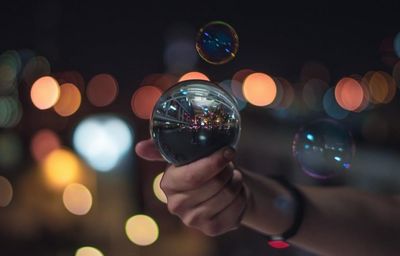 Close-up of hand holding bubbles