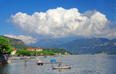 Boats in river against landscape