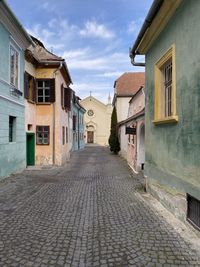 Empty alley amidst buildings in town