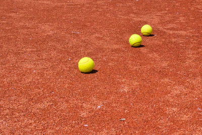 High angle view of yellow tennis balls on tennis  court