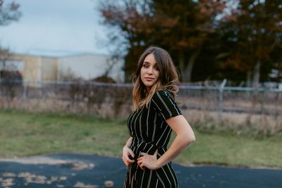 Fashionable teenage girl standing outdoors