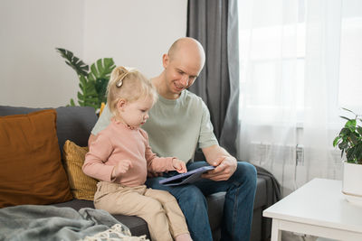 Mother using digital tablet at home