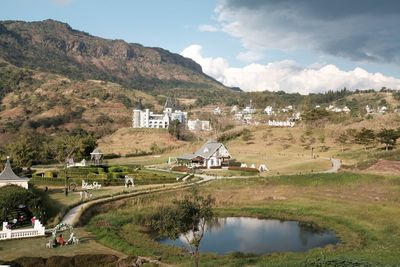 Scenic view of lake by buildings against sky