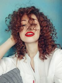 Close-up portrait of smiling woman with curly hair