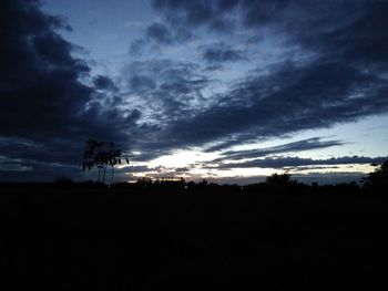 Low angle view of silhouette landscape against sky