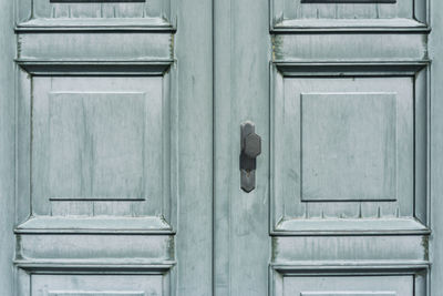 Full frame shot of green wooden door during sunny day