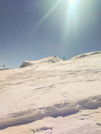 Low angle view of desert against clear sky during sunny day