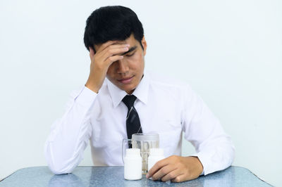 Young man sitting on table