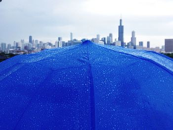 View of cityscape against blue sky