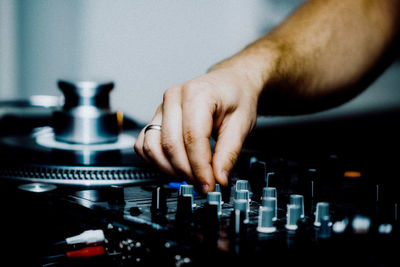 Cropped hand of man mixing music
