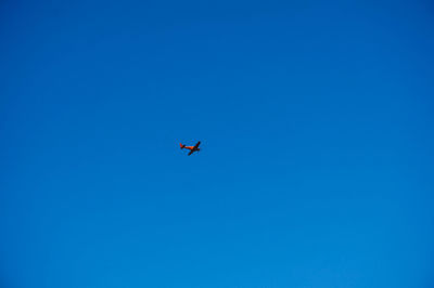 Low angle view of airplane flying in sky