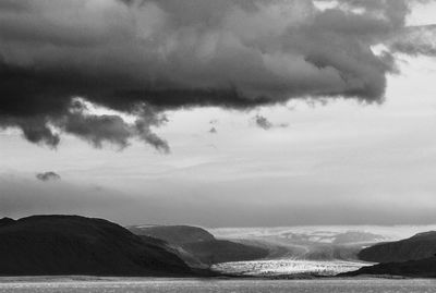 View of calm sea against cloudy sky