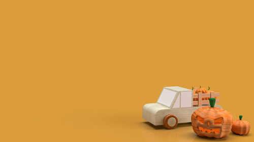 Close-up of toy car against orange background