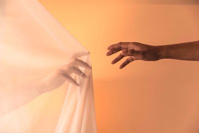 Close-up of hands against white background